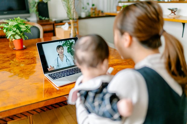 woman and baby doing video chat with doctor woman and baby doing video chat with doctor